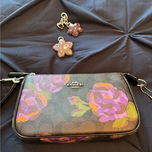 Coach wristlet or small hand carry bag; like new; Rose print; purple bag charms.